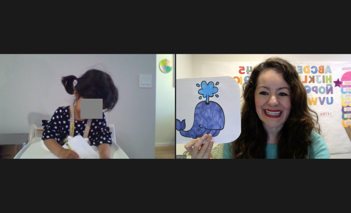 Sergi in a private video class showing picture of whale with young child drawing